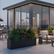 Wide low rectangular matte charcoal fiberglass planter styled in a sophisticated modern interior with tropical plants